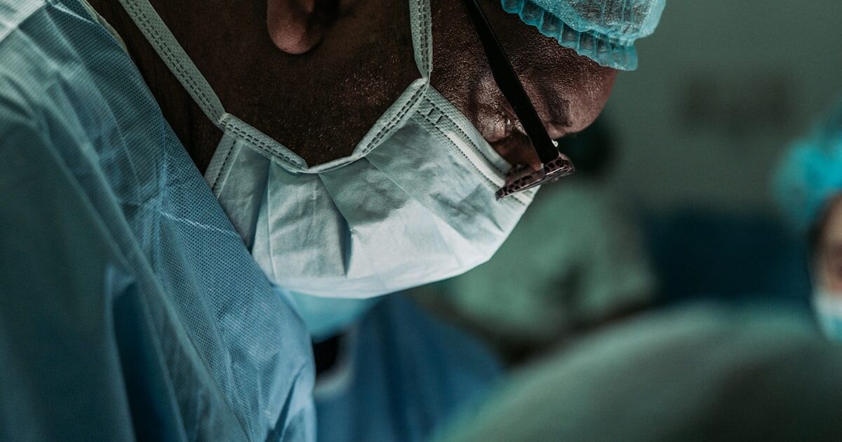 A traditional weekly pill organizer placed next to a smartphone displaying a medication reminder app interface